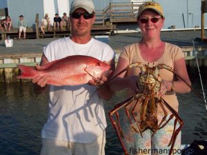 Tracy and Howard with an American red snapper and a lobster they hooked on squid while fishing 40 miles off Topsail on the headboat "Vonda Kay" with Capt. Dave Gardner.