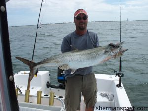 Jon Supanich, of Oak Island, with his new boat's first king mackerel. The 50", 29 lb. smoker fell for a cigar minnow just off the beach at Oak Island while Jon was fishing with his nephew Mark.