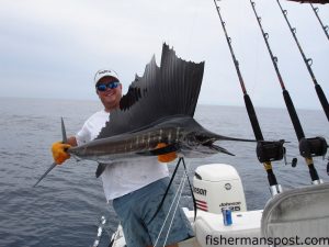 Capt. Clint Richardson with a sailfish that fell for a naked ballyhoo 20 miles off Wrightsville Beach while he was fishing aboard his boat, the "Finatic," with Charles Booth.