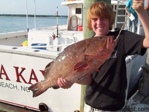 Jarret Morris (age 12), of Woodruff, SC, with a 12 lb. red grouper he hooked on a squid while fishing offshore of Topsail Beach on the headboat "Vonda Kay" with Capt. Dave Gardner.