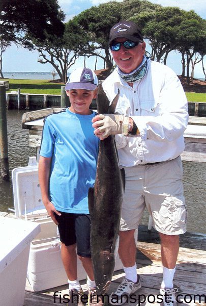 Richard Wolf (left), of Annandale, NJ, with his first cobia. The 28 lb. cobe hit a trolled ballyhoo about 22 miles out of Beaufort Inlet. He was fishing on his pop pop's boat the "Kelly Ann."