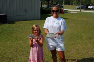 Ella and Meredith Perry, of Wilmington, with the .76 and .90 lb. first and second place pinfish in the Sneads Ferry Lions Club Pinfish Tournament. They hooked their pinfish on cut spanish mackerel near Seapath Marina.