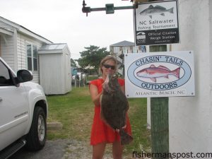 Natalie Paul, from Raleigh, with her first flounder, an 8.32 lb. doormat that fell for a live bait underneath the Atlantic Beach Bridge. Photo courtesy of Chasin Tails Outdoors.