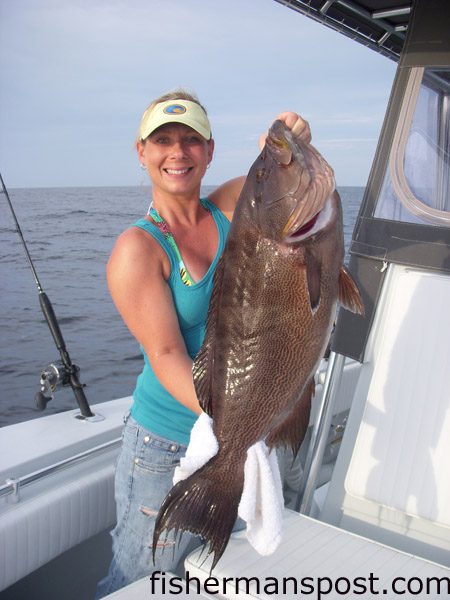 Andrea Nelson, of Wilmington, with an 18 lb. scamp that fell for a live cigar minnow while she was fishing in 100' of Wrightsville Beach with Nick Patsalos on the "Slip Slidin."