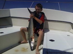 Cole Radford (age 8) with his first king mackerel. He hooked the fish on the Fourth of July at Ar-285 East of Cape Lookout while fishing with his father Kevin on the "Brown Eyed Girl."