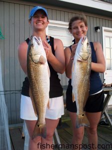 Carlin Williford and Anna Godley, from Raleigh, with a pair of upper-slot red drum they hooked on Carolina-rigged finger mullet in the marsh near Swansboro. They were fishing with Capt. Rob Koraly of Sandbar Safari Charters.