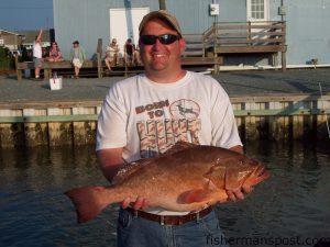 Jason, from Sioux Falls, SD, with a red grouper he hooked on a cigar minnow while fishing 40 miles off Topsail on the headboat "Vonda Kay" with Capt. Dave Gardner.