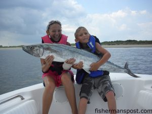 Madison (age 11) and Preston (age 7) Spangler with a 30 lb. king mackerel Madison hooked at Lighthouse Rocks while fishing with Tucker Pacula on the "Tide One On."