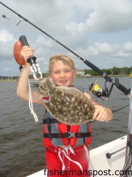 Hunter Rivenbark (age 7) with a 17″ flounder he hooked in Carolina Beach Inlet on a live pogy while fishing with Capt. Kevin Smith of Speck Tackler Sport Fishing.