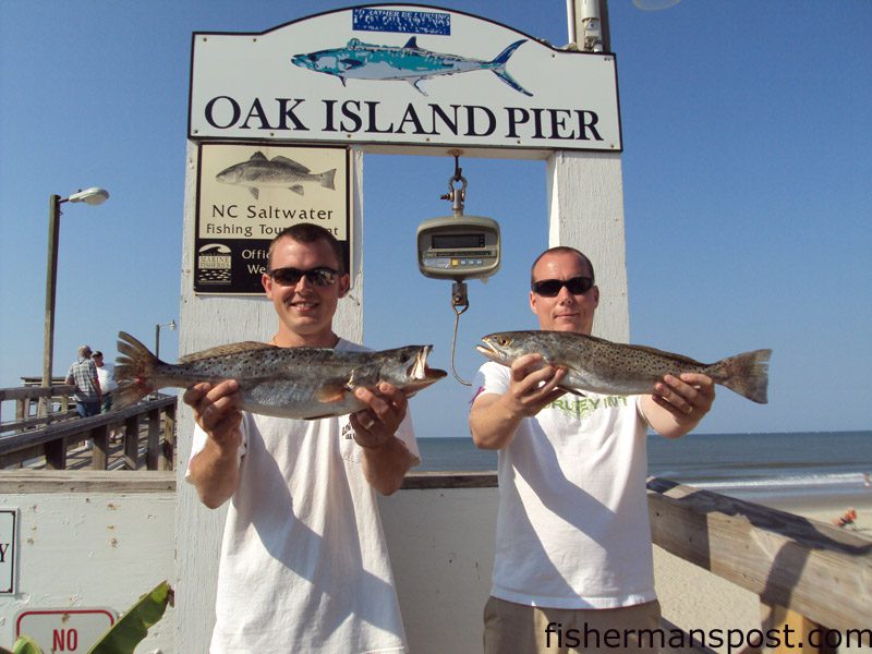 Wesley Brown and Tommy Thomes, Jr. with 3.5 and 2.6 lb. speckled trout they hooked on live shrimp while fishing from Oak Island Pier.