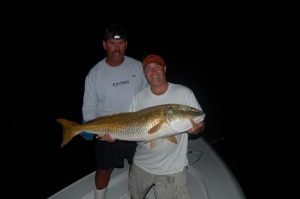Capt. Charles Brown, of Old Core Sound Guide Service and Eddie Hardgrove (or the Little Feller) with his first citation red drum, a 47" fish that fell for a chunk of mullet at a 1' slough in the bottom of the Pamlico Sound near Cedar Island.