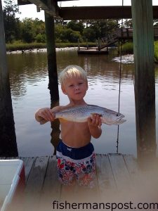 Owen Parker Bell (age 2), of Oak Island, with a gray trout he hooked on a live shrimp at Yaupon Reef. He was fishing with his father Wesley and uncle Tommy.