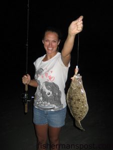Melanie McCall with her first flounder, which fell for a 4" New Penny Gulp shrimp at the south end of Wrightsville Beach.