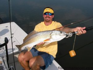 Russell Farlow, of Archdale, NC, with a 30" red drum he caught in the ICW near Figure Eight on a a topwater plug while fishing with his brother Jim and Capt. Jon Huff of Circle H Charters.