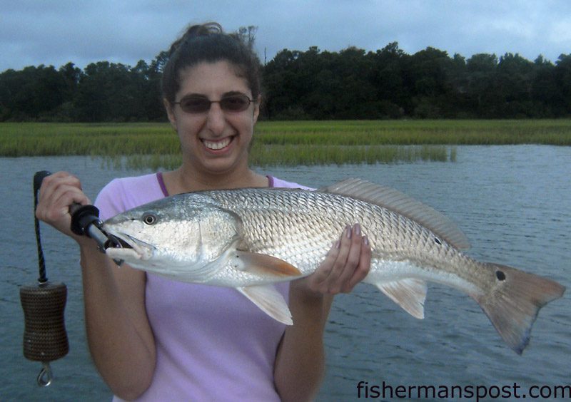 Stephanie Ose with an 8 lb. red drum that fell for a silver spoon on her third cast while she was fishing for the first time with Capt. Mike Pedersen of No Excuses Charters.