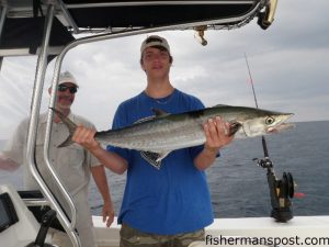 Taylor Brown, of Mebane, NC, with a teenager king mackerel he caught while fishing with Capt. Jim Sabella of Plan 9 Fishing Charters out of Topsail Beach. The fish ate a cigar minnow fished on a Bluewater Candy dead bait rig with pink Bling skirt near Honeymoon Rock.