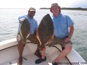 Jeremy Jeffers and Brandon Faucette, from Goldsboro, NC, with 18" and 28" flounder they hooked in the turning basin aboard the "Wet Chemistry." The larger flounder weighed 9.75 lbs. at EJW Outdoors.