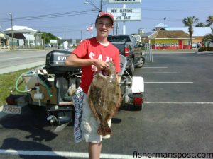 Hunter Kinlaw (age 13), from Alpharetta, GA, with an 8 lb., 8 oz. flounder he hooked in Carolina Beach Inlet on a live pogy while fishing with his father Jay.