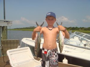 Nathan Yow with spanish mackerel he hooked on Clarkspoons while trolling the beach off Oak Island with his father, Jeff Yow of Chatlee Boat and Marine.