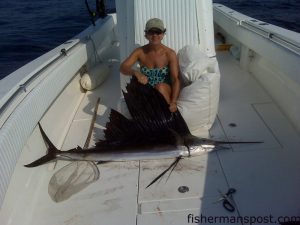 Susan Turnage with a sailfish she caught and released at the George Summerlin reef on a live pogy while fishing with her husband Mike on the "Zacanator."