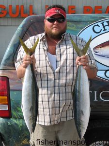 Johnnie Driver, of Morehead City, with a pair of 8+ lb. rainbow runners he hooked on squid under sea witches near the Big Rock. Photo courtesy of Chasin Tails Outdoors.