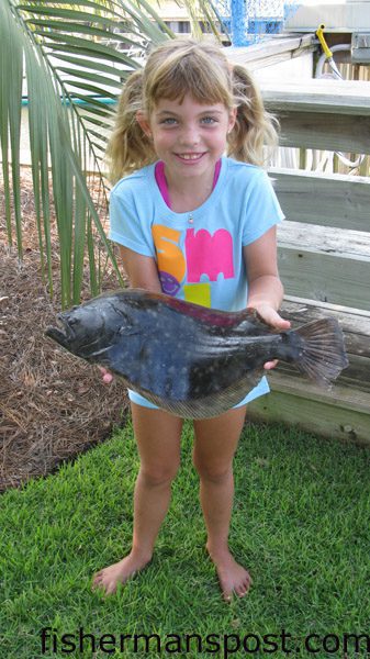 Brooke McIntyre (age 6), of Wilmington, with her first flounder, a 2.5 lb. fish she hooked on a live pogy while fishing from her dock at Inlet Point.