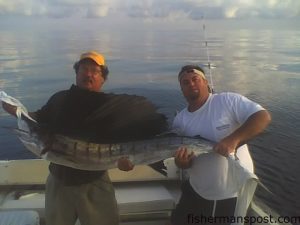 John Hatfield and James Bullock with a sailfish hooked 20 miles off Carolina Beach while they were fishing on the "Cut-N-Close."