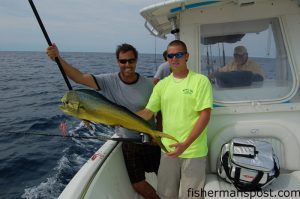 Gary Hurley and Capt. Adam Powell, of All In Charters, show off one of several gaffer dolphin that fell for a cigar minnnow under the "UF Special" orange and blue Blue Water Candy skirt at a spot in 100' of water 30 miles out of New River Inlet.