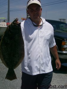 Mike Campbelle with a 6 lb. flounder he hooked near Topsail on a live peanut pogy while fishing with Capt. Wayne Crisco of Last Resort Charters.