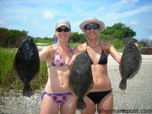 Sarah Brownlee and Tania Atwood with their first flounders. They hooked the flatties on Gulp baits and cut shrimp around docks in Pages Creek.