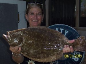Anita Popplewell, from Fayetteville, NC, with a 3.71 lb. flounder she hooked on a cut bait while fishing from Surf City Pier.