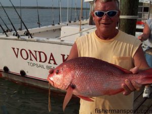 Robert Harrelson, a mate on the "Carolina Princess" with an American red snapper he hooked while fishing off Topsail on the headboat "Vonda Kay" with Capt. Dave Gardner.