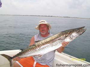 Glenn Badders with a 42 lb. king mackerel he hooked off New River Inlet while fishing with his wife Brenda.
