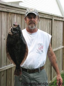 Scott Thurston, of Swansboro, with a 22" 4 lb., 3 oz. flounder that attacked a Fish Bites paddle tail grub in Queen's Creek.