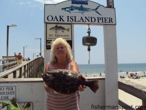 Judy Oxendine, of Oak Island with a 4.2 lb. flounder she hooked on a live shrimp while fishing from Oak Island Pier.