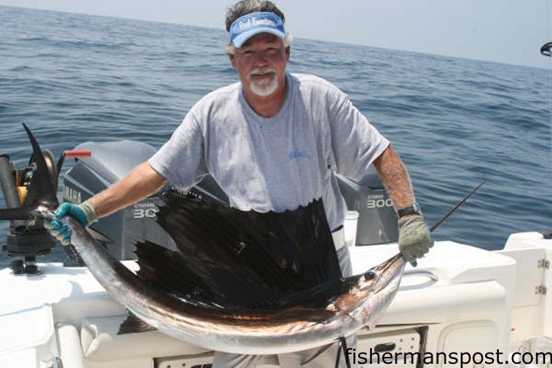 Mitchell "Capt. Big Fish Mitch" Cartee, from Holden Beach, with a sailfish that took a live pogy at 15 Mile Rock while he was fishing with Todd Schad on the "Diggin It."