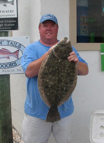 Carl Malpass, Jr., of Raleigh, with an 11.34 lb. flounder he hooked on a live bait at the Morehead port wall. Weighed in at Chasin' Tails Outdoors.