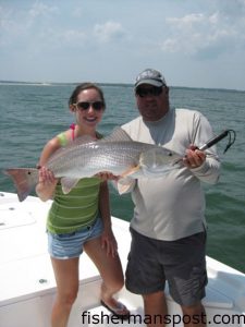 Megan Hunter, from Kernersville, NC, with a well over-slot red drum she hooked on a live pogy at the Little River jetties while fishing with Capt. Mark Dickson of Shallow Minded Fishing Charters.