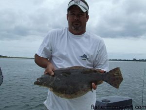 Danny Robbins, of Little River, with a flounder he hooked in Little River Inlet on a 6" finger mullet.