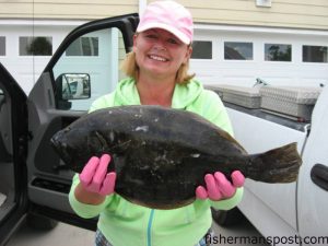 Larysa Biloholowskyj with a 21" flounder she hooked on her first trip kayak fishing. The flattie fell for a live finger mullet in the backwaters at Fort Fisher.