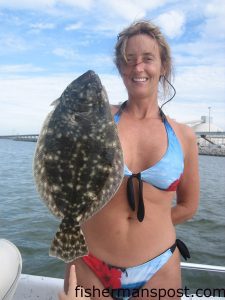 Alyce McDonald with a flounder that fell for a live finger mullet in the Haystacks.