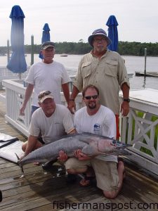 Same Mcdoland, Tim Bullard, Bruce Martin, and Gabe Heinisch with a 61 lb. wahoo that Gabe caught while high-speed trolling a 15" Mike's Big Bite lure near the Same Ol' Hole.