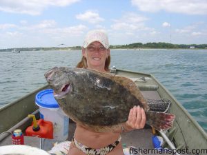 Barb Smith with a 7.8 lb. flounder she hooked in Carolina Beach Inlet on a live finger mullet while fishing with Harry Gierzewski.