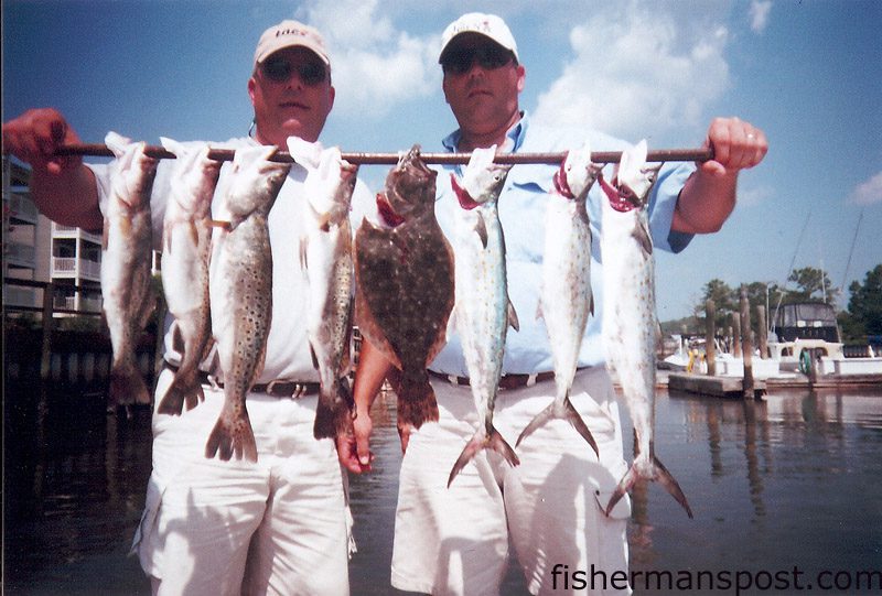 Patrick and Dale Allman, from Cleveland and Mt. Holly, with a stringer of speckled trout, spanish mackerel, and a flounder caught near Oak Island using live peanut pogies. They were fishing with Capt. Greer Hughes of Cool Runnings Charters out of Southport.