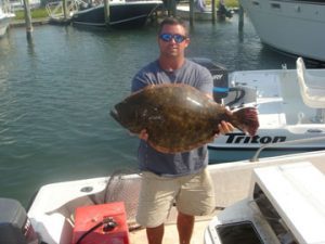 Dennis Durham, of Wilmington, with the 10 lb. flounder that topped the field at the Third Annual Masonboro District Flounder Tournament. Durham hooked the flatfish on a live pogy in Snow's Cut.