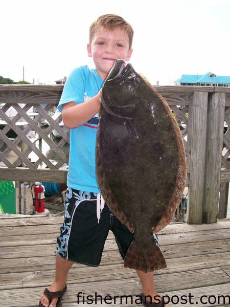 Will Jordan, of Burgaw, NC, with a 7.7 lb. flounder he hooked on a live finger mullet near Wrightsville Beach.