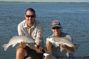 Max Gaspeny and Gary Hurley with a pair of mid-slot red drum that fell for finger mullet on jigheads at a marsh point off the lower Cape Fear River.