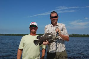 Capt. Jeff Wolfe, of Seahawk Inshore Fishing Charters, and Max Gaspeny with a tripletail that fell for a sight-casted live shrimp beneath a popping cork near a crab trap float in the Cape Fear River.
