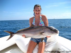 Brenna Parker, of Four Oaks, NC, with an amberjack she hooked inshore of WR2 on a Blue Water Candy-skirted ballyhoo and released after the photo was taken. She was fishing with Ken Holt aboard the "Cattle Company."