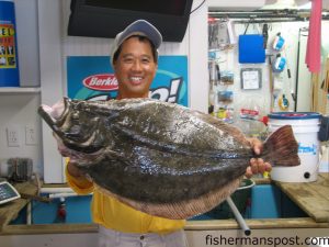Alex Ng, from Atlantic Beach, with a 13.66 lb. flounder that fell for a live pogy at a secret flounder spot inshore near Morehead City. Weighed in at Chasin Tails Outdoors.